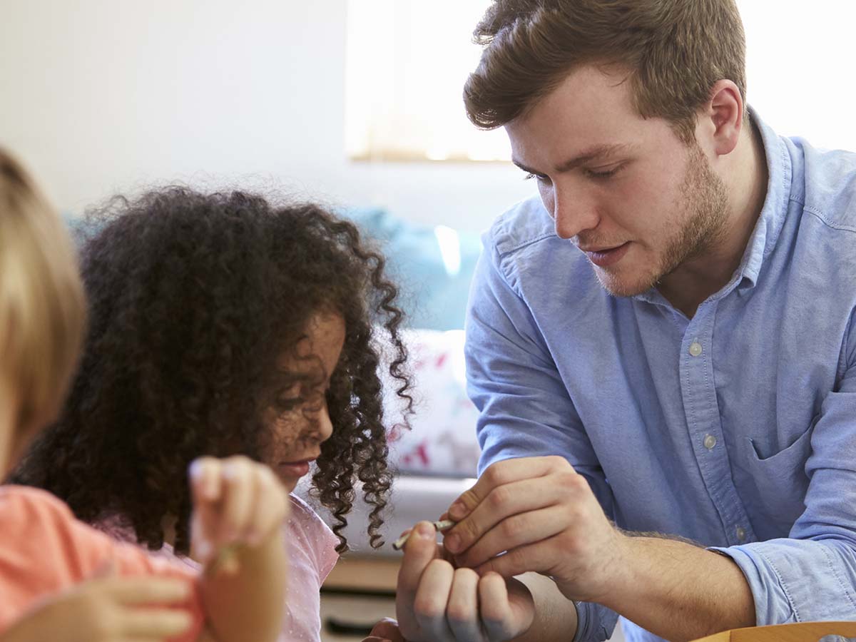 a teacher teaching a young student