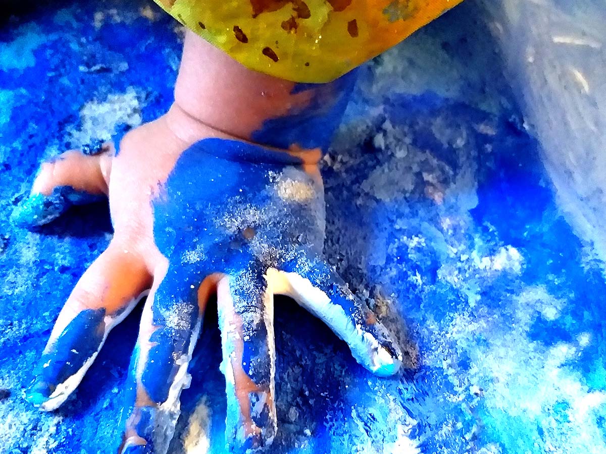 a young child finger paints