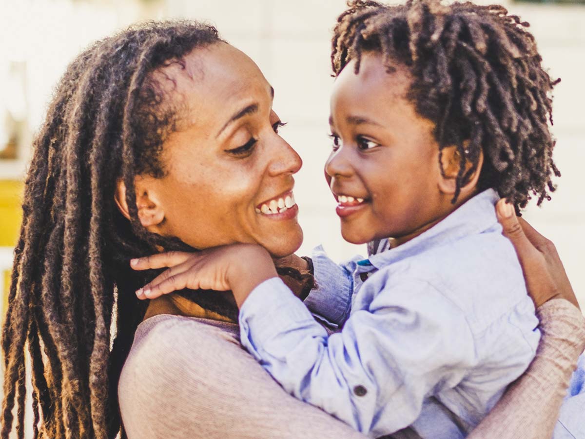 a woman holding a smiling child