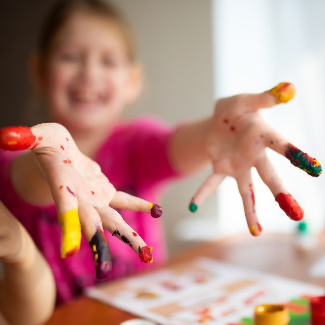 child with paint on fingers