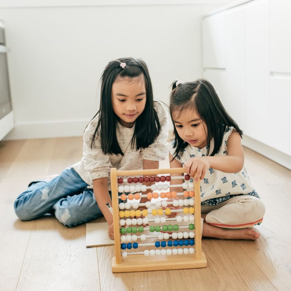 Two asian siblings playing with a toy