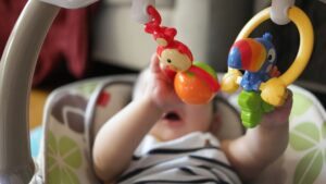 Young baby playing with a toy.