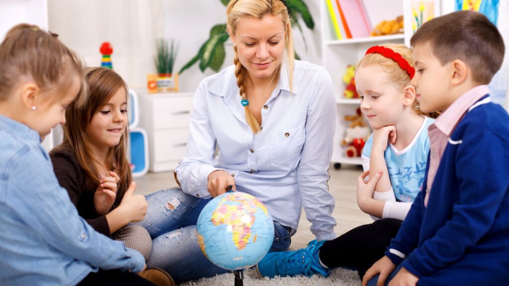 preschool kids looking at globe
