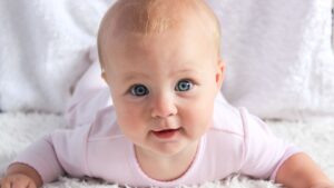 An infant lying on their stomach