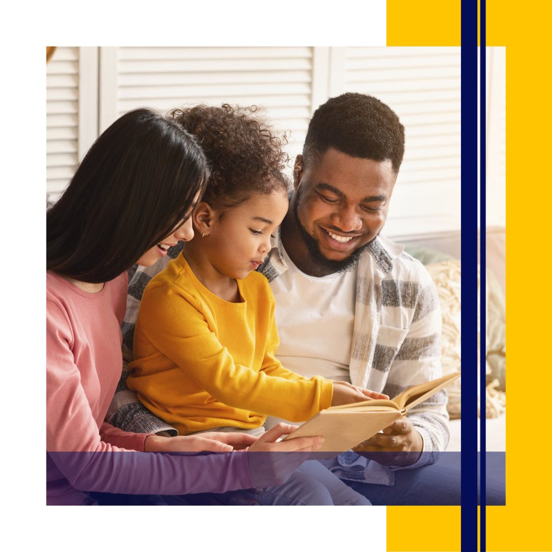 Parents and child smiling while reading a book together
