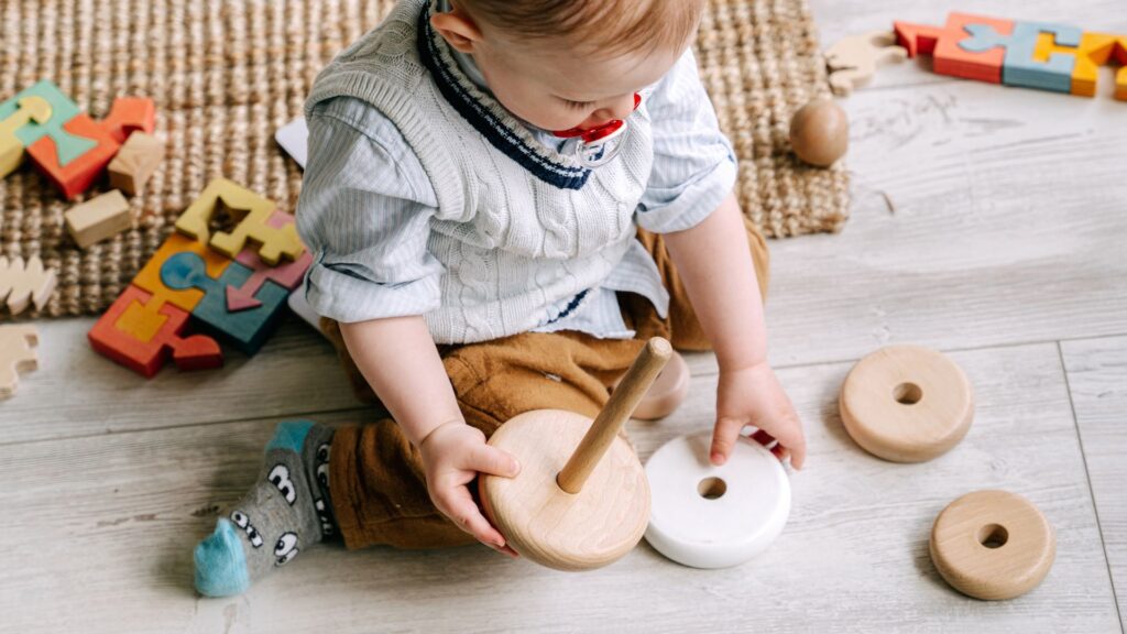 an infant playing with toys