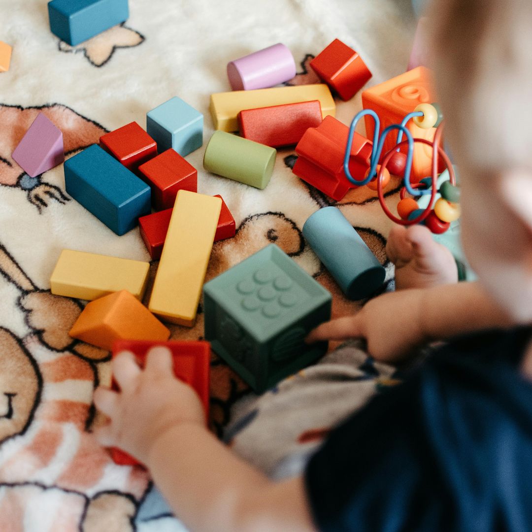 an infant playing with blocks