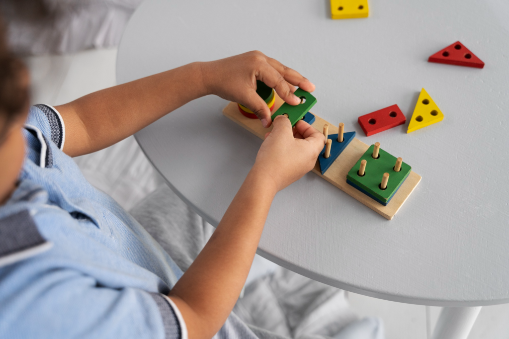 A child carefully fits colorful geometric blocks into a wooden puzzle board to develop spatial reasoning.