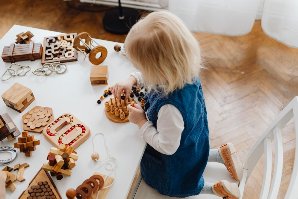 Young child building with wooden blocks to strengthen problem-solving skills.