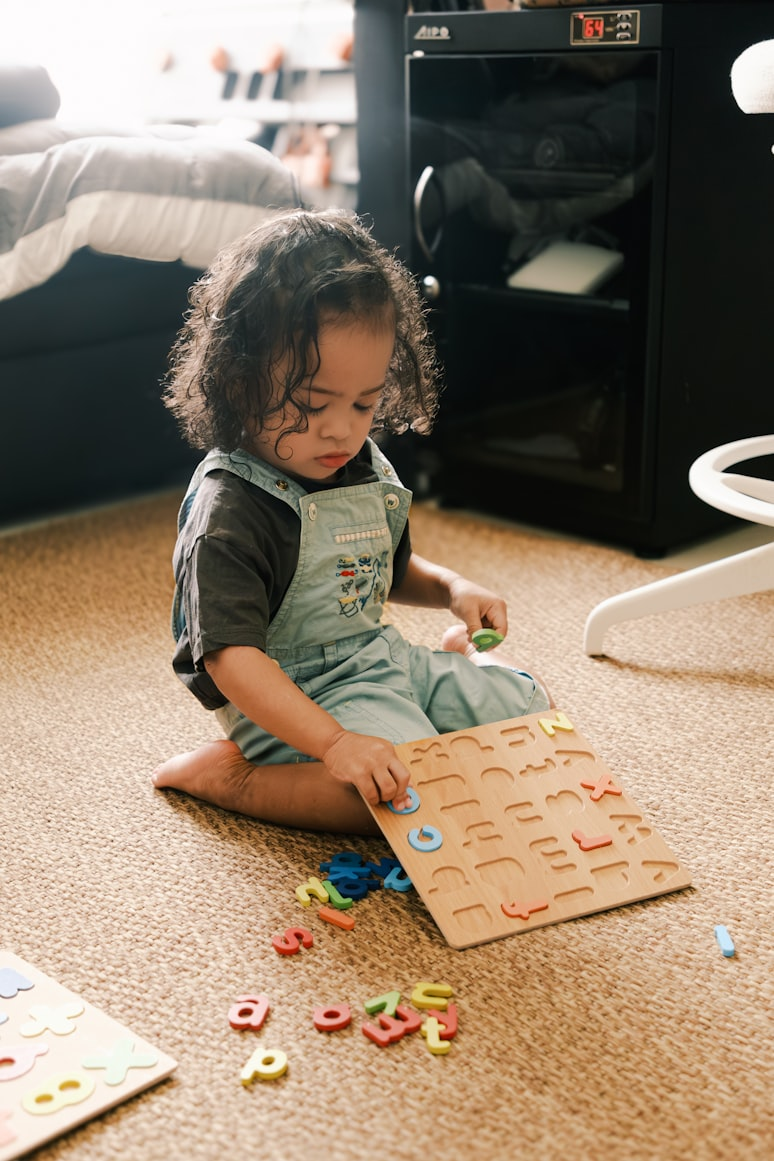  Young child solving an alphabet puzzle to build early literacy skills.