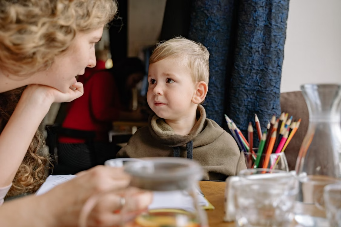 Mother making eye contact while talking with her young son.