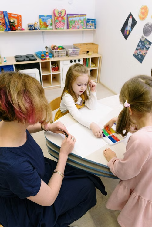 Young child practicing a stacking activity with hands-on learning materials.